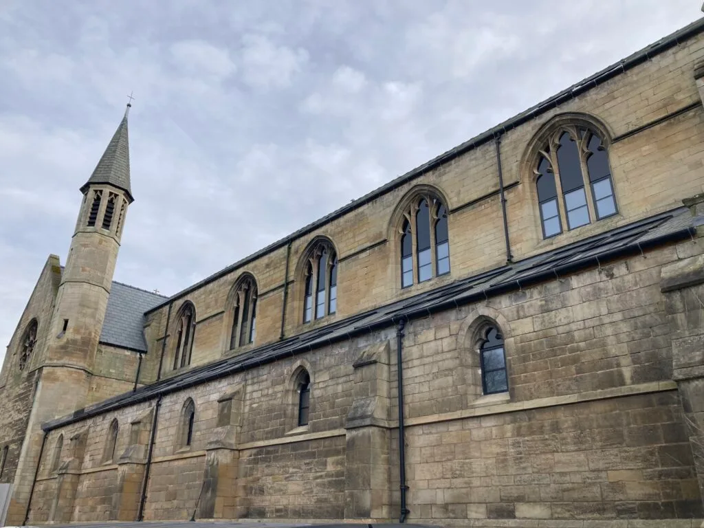 Church side after 3D scanning stonework and window restoration, showing completed work.