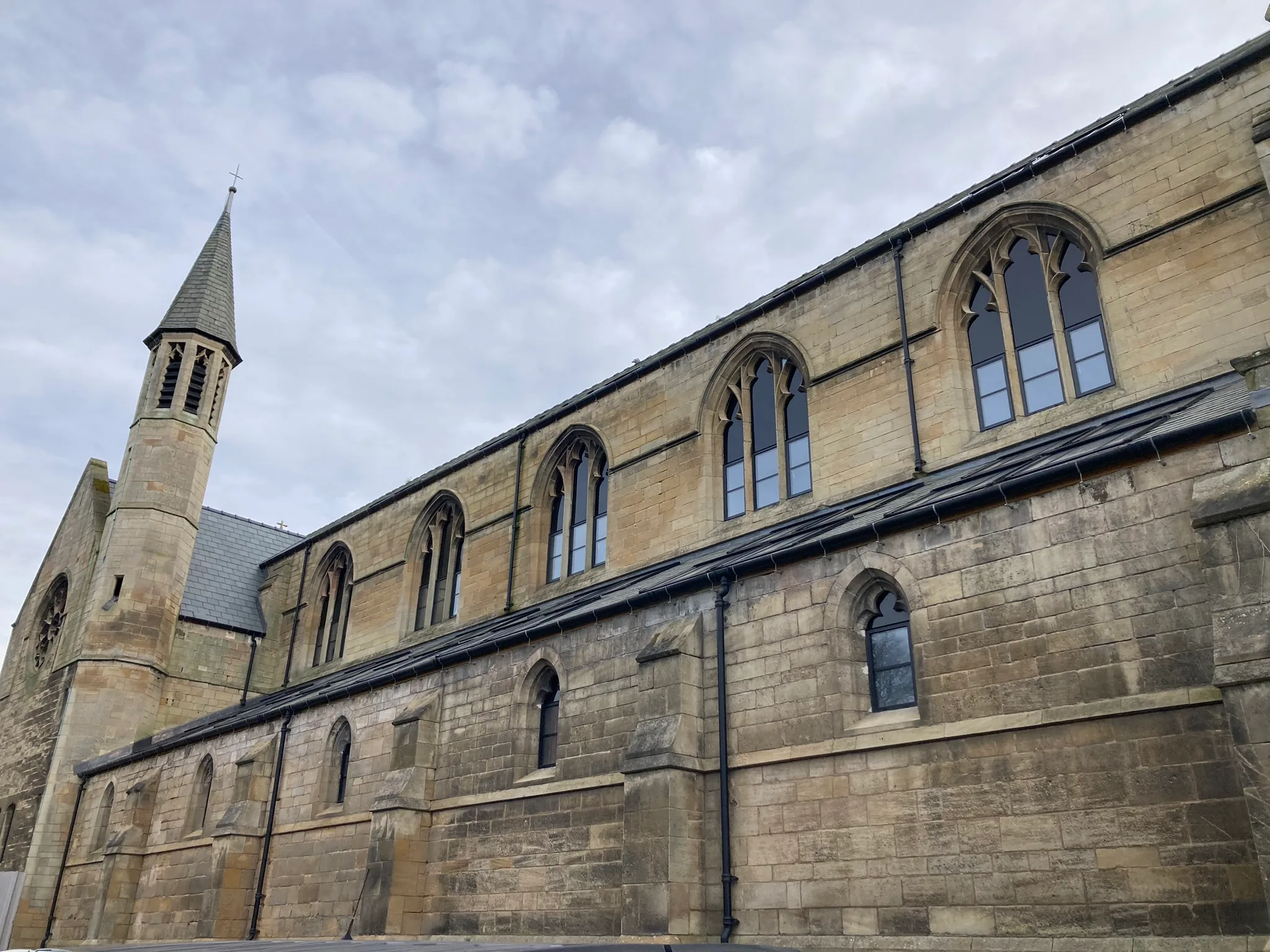 Church side after 3D scanning stonework and window restoration, showing completed work.