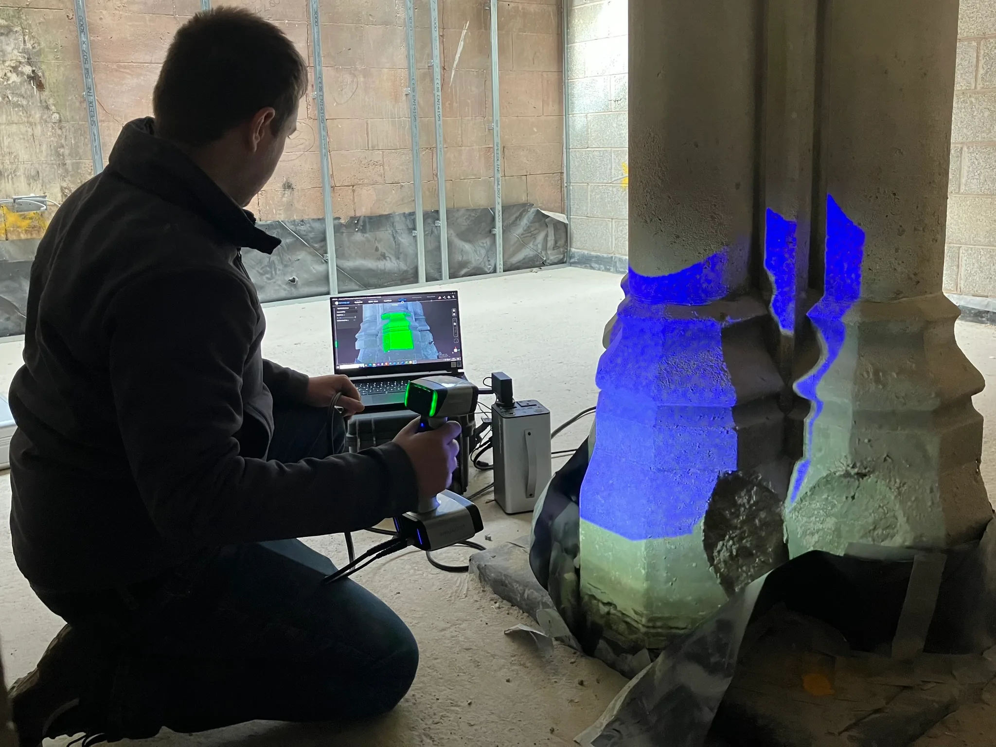 Photo showing the 3D scanning of the interior stonework. The scanned area shown a laptop screen.